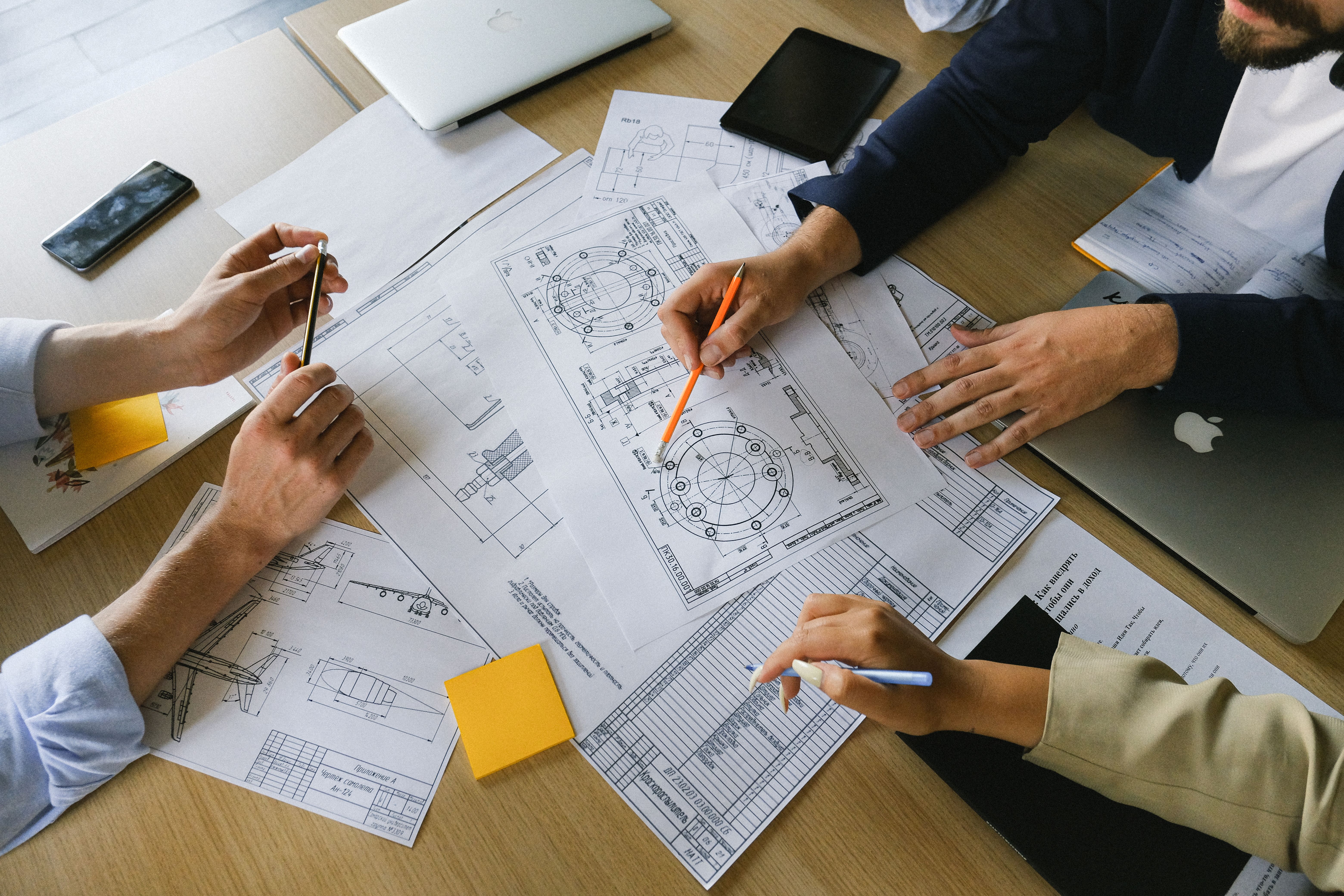 Team working on technical drawings